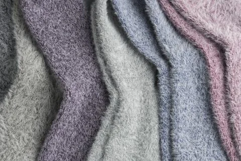 Close-up of soft fluffy pastel socks shows delicate texture and gentle colors Stock Photos
