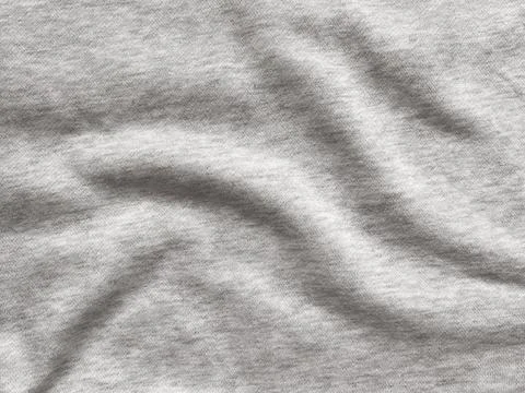 Close-up of a soft grey fabric texture with folds and shadows Stock Photos