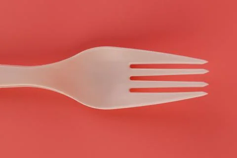 Close up soft pink background pair of plastic white forks disposable tableware Stock Photos