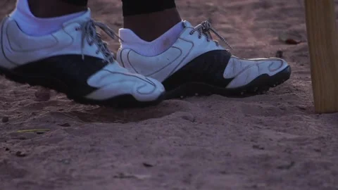 A close-up softball shoe dealing with the ground Stock Footage 143912515