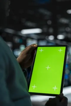 Close up of software developer in data center using green screen tablet Stock Photos