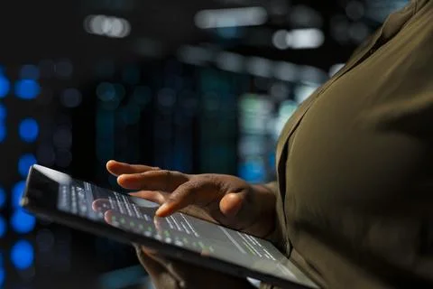 Close up of software developer implementing security measures in data center 写真素材