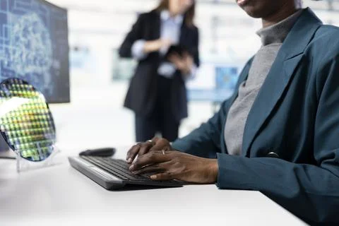 Close up of software developer in microchip factory RD office training AI model Foto stock