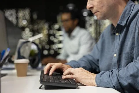 Close up of software developer typing on PC keyboard in startup office 스톡 사진