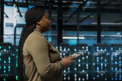 Close up of software developer using device to do maintenance in data center 스톡 사진