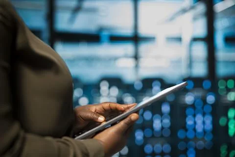 Close up of software developer using tablet in data center to track metrics 스톡 사진