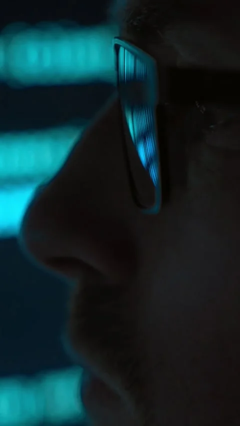 Close up, software engineer in glasses looking at programming code in a dark Stock-Footage 345446279