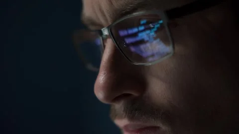 Close up of software engineer with green code reflecting on his eyeglasses. Stock Footage 308016169