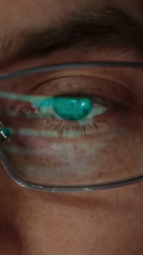 Close-up of a software engineer s eye with source code reflected in eyeglasses Stock Footage 314259620