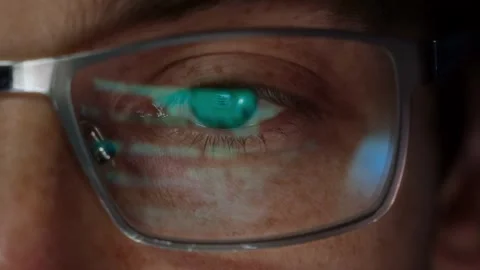 Close-up of a software engineer s eye with source code reflected in eyeglasses Stock Footage 317987912