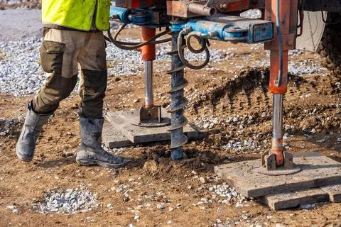 Close-up of soil sampling during pile drilling process. Extraction of subsurface Stock Photos