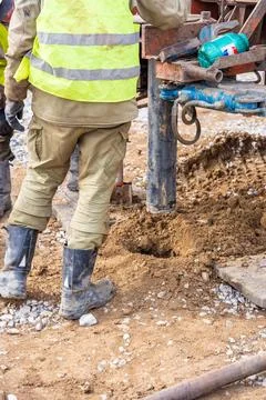 Close-up of soil sampling during pile drilling process. Extraction of subsurface Stock Photos