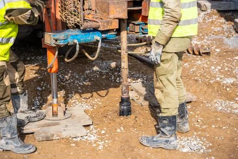 Close-up of soil sampling during pile drilling process. Extraction of subsurface Stock Photos