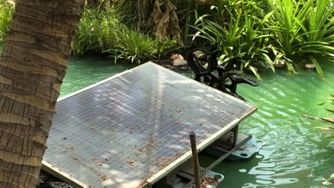 Close-up of a solar cell paddle wheel aerator running in a small canal of a Stock Footage 311036447