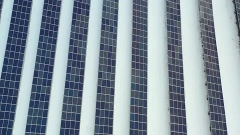 Close up solar farm standing in rows of modern photovoltaic panels in at winter Stock Footage 169875701