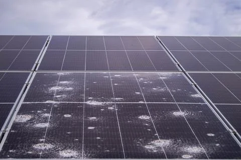 Close-up of solar panel damage caused by hailstorm, showcasing cracked and .. Stock Photos