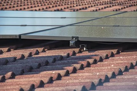 Close-Up of Solar Panel Mounting System Above Tiled Roof Stock Photos