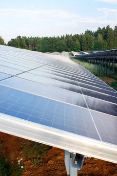 Close-up of solar panels array on a photovoltaic farm station generating clea Stock Photos