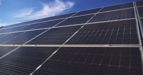 Close up of solar panels generating clean renewable energy under blue sky Stock Footage 302275603