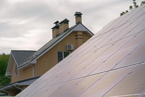 Close-up of solar panels installed on historic building gable roof with chimn Stock Photos