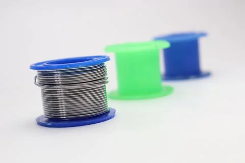 Close up of solder wire spool with empty blue and green spools Stock Photos