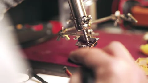 Close up Soldering a circuit using a soldering hair dryer hot Air Soldering Iron Stock Footage 229629938
