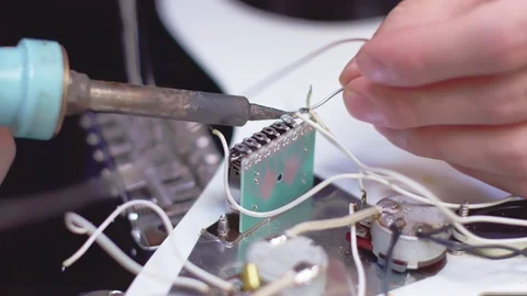 Close up of soldering electrical element of a guitar Stock Footage 118017189