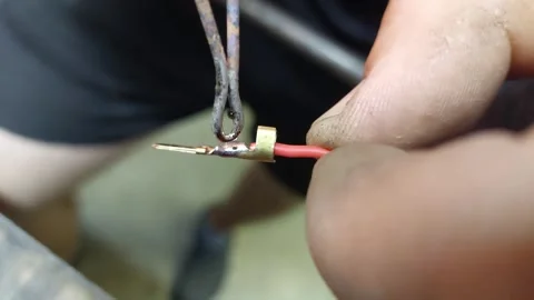 Close up of soldering iron joining electrical wire and metal spade terminal conn Stockbeeldmateriaal 346245738