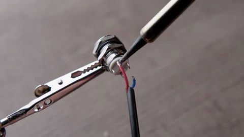 Close-up of Soldering Iron Tip Connecting Red Wire to Electronic Component Video stock 332227351