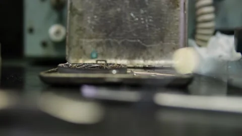 Close-up of a soldering iron tip emitting smoke while working on an electronic Stock Footage 300550059
