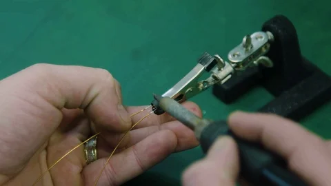 Close up soldering small parts at the electronics department. Plant worker Video stock 104594984