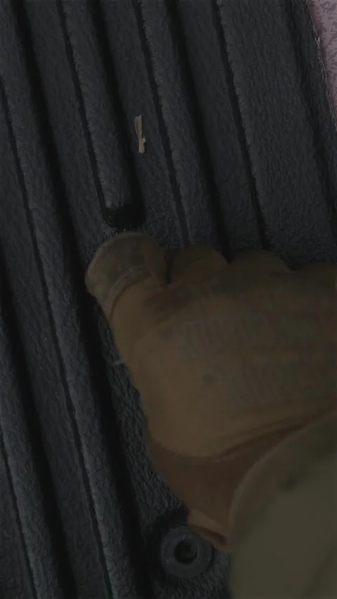 Close-up of soldier in gloves carefully sorting rifle ammunition on pickup .. Stock Footage 333612714