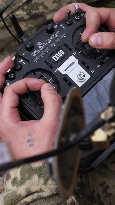 Close-up of soldier hands controlling FPV drone with RadioMaster TX16S remote Stock Footage 333612711