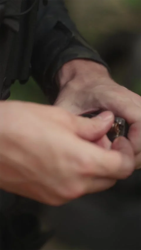 Close-up of soldier hands loading 7.62mm ammo into AK magazine Stock Footage 333612699