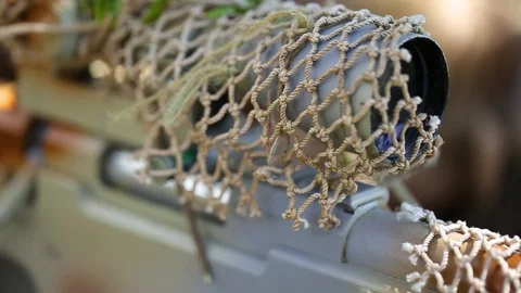 Close-up. Soldier looking through sniper scope. Ghillie suit. Tracking the enemy Stock Footage 127629233