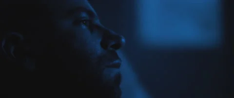 Close up of a soldier sitting alone in a room, dealing with PTSD. Stock Footage 147540435