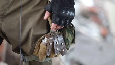 Close-up of a soldier in tactical gloves with a grenade in a pouch Stock Footage 101805565