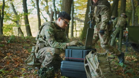 Close up soldier using laptop computer for surveillance during a military 動画素材 242423590