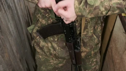 Close-up of soldier's hands reloading weapon and stepping forward. Stock Footage 266397896