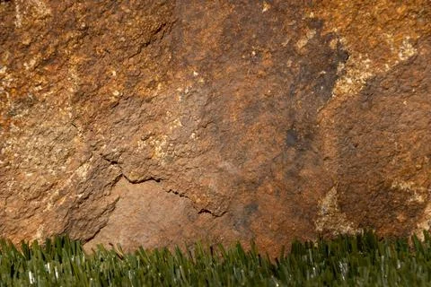 Close up of a solid granite rock in a variety of yellow and brown shades 写真素材