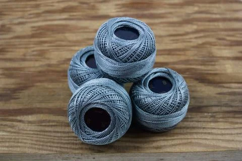 Close-up of some balls of quality gray pearl thread on an old wood Stock Photos