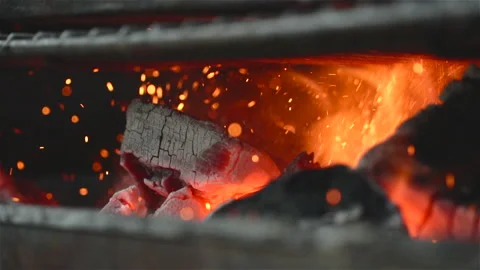 Close up of some charcoal burning in a grill in slow motion Stock Footage 137523831