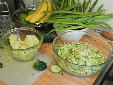 Close up of some grated courgette being prepared on a kitchen work surface Foto stock