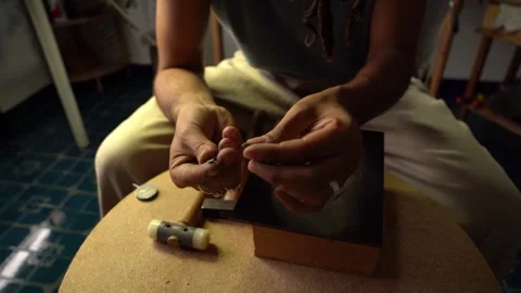 Close up some hands mounting a precious stone. Goldsmith workshop Stock Footage 253390243