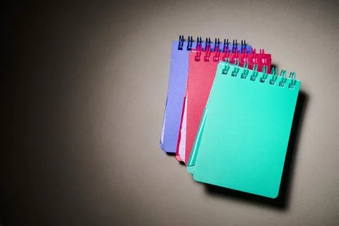 Close-up of some small spiral notebooks on a desk. Stock Photos