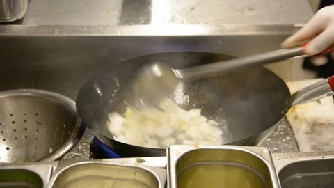 Close up someone cooking in wok pan. Vegetable curry being seasoned with spices Stock Footage 106622067
