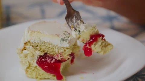 Close-up of someone enjoying cake with red jam Stock Footage 336044249