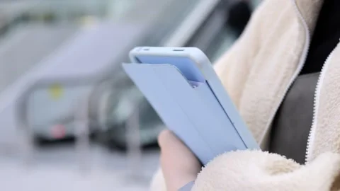 Close-up of someone using a tablet during elevator ride Stock Footage 348228444