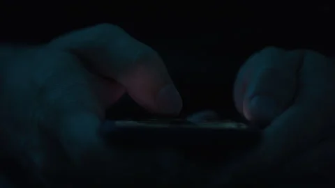 Close up of Someone's Hands Scrolling on Their Cell Phone in the Dark Stock Footage 270391828
