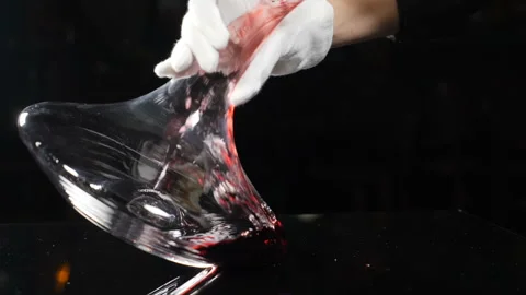Close-up of sommelier pouring red wine into decanter in slow motion. Wine Stock Footage 122414564